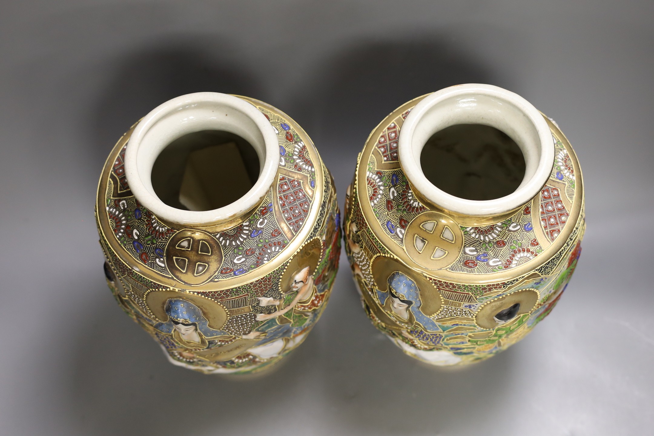 A pair of Japanese moulded and moriage decorated vases, 31cms